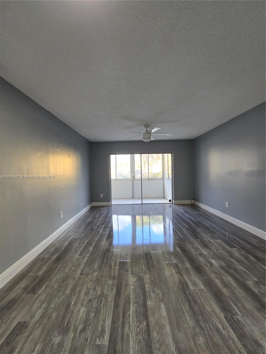 2800 Northwest 56th Avenue, Unit C104 Lauderhill, FL 33313 - Photo 8 of 17 wooden floor in an empty room with a window