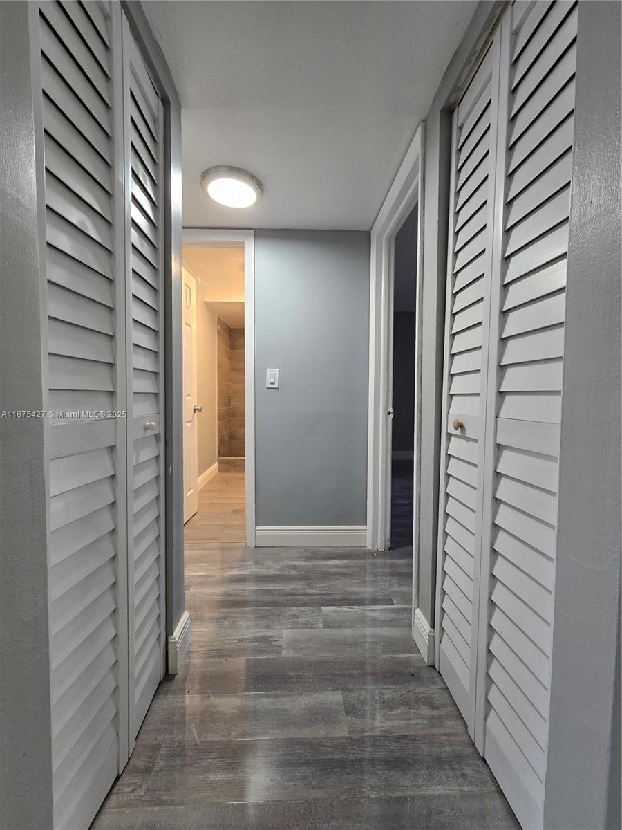 2800 Northwest 56th Avenue, Unit C104 Lauderhill, FL 33313 - Photo 9 of 17 a view of a hallway with wooden shelves