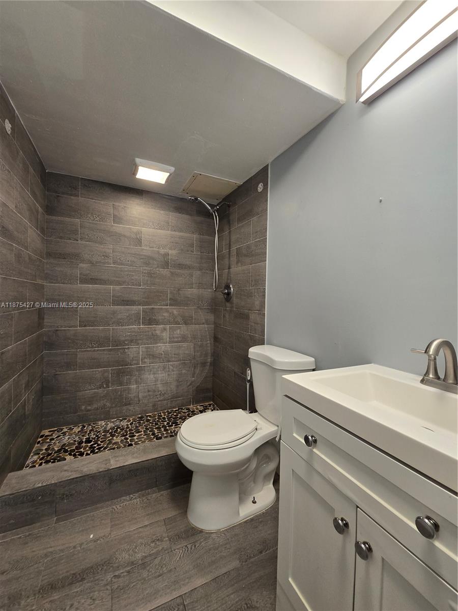2800 Northwest 56th Avenue, Unit C104 Lauderhill, FL 33313 - Photo 10 of 17 a bathroom with a sink a toilet and shower