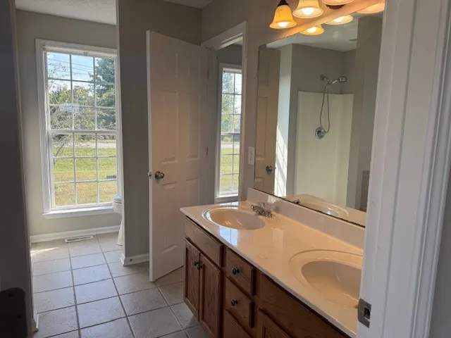 a bathroom with a sink a vanity and a mirror
