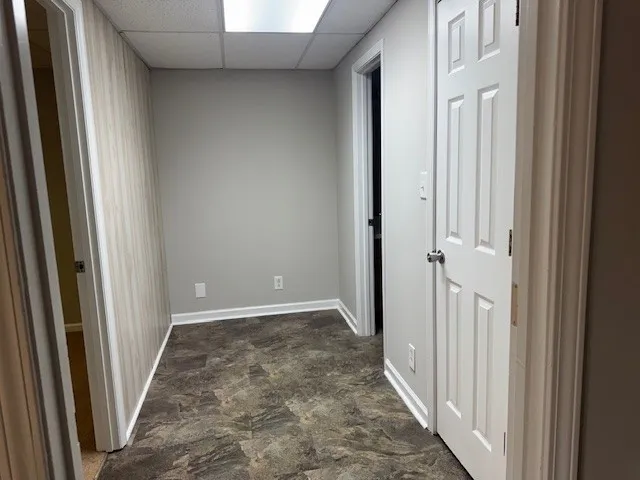 a view of a hallway with wooden floor and entryway