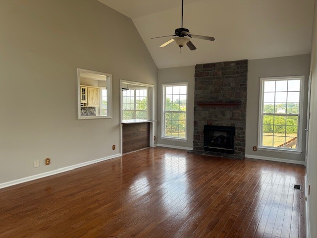 251 7 Mile Ferry Road Cunningham, TN 37052 - Photo 7 of 36 an empty room with wooden floor a fireplace and windows