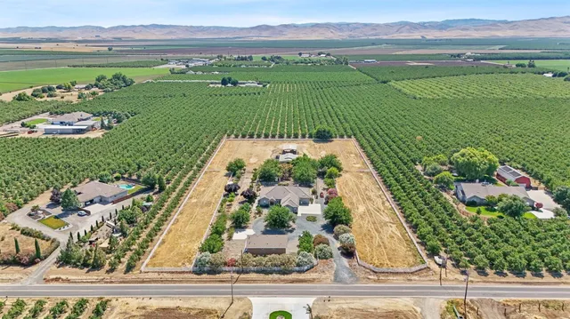 an aerial view of a house with a yard basket ball court and outdoor seating