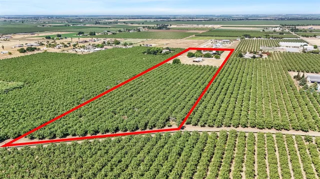an aerial view of a house with a yard and lake view