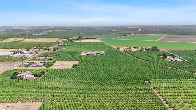 a kitchen with a table chairs refrigerator and cabinets