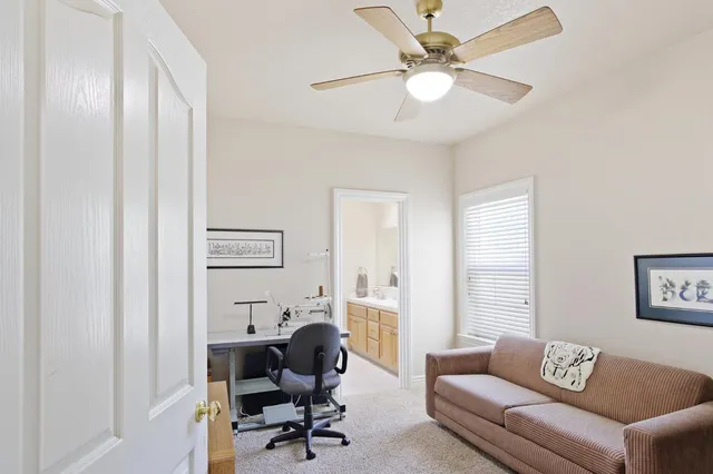 a view of a workspace with furniture and a flat screen tv