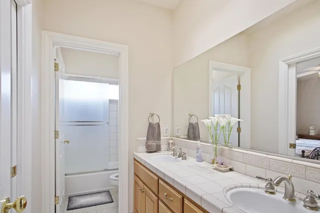 a bedroom with furniture and a large window