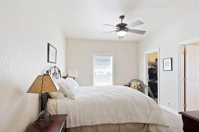a view of a house with backyard and trees