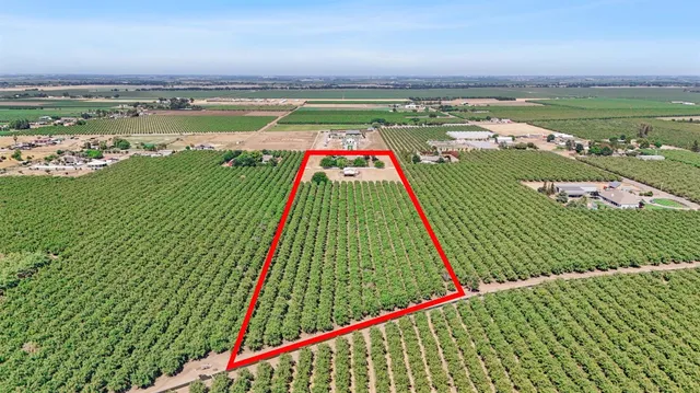 an aerial view of a house a garden and mountain view in back