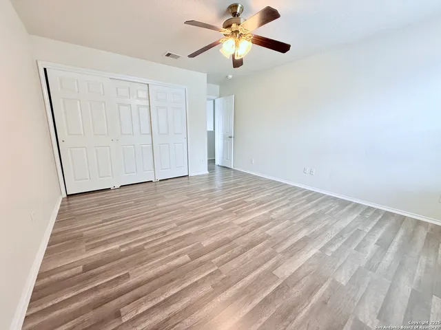 a view of empty room with wooden floor
