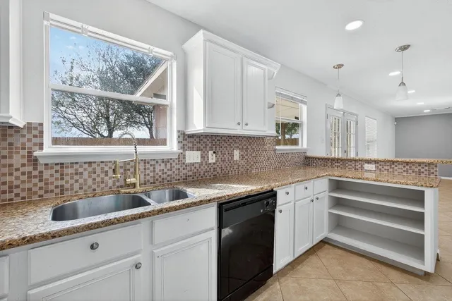 a kitchen with a sink and cabinets
