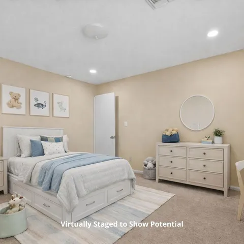 a bedroom with a large bed and window