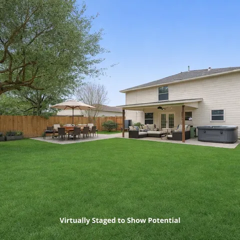 a view of an house with backyard space and sitting area