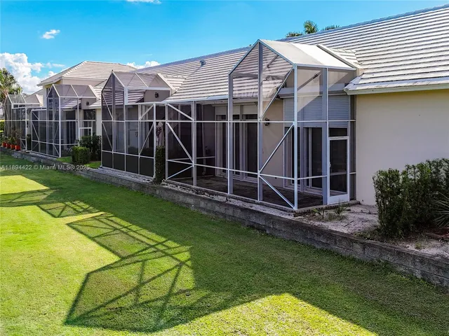 a view of a yard with wooden fence