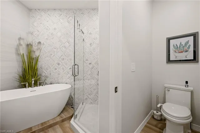 a white bath tub sitting next to a white toilet