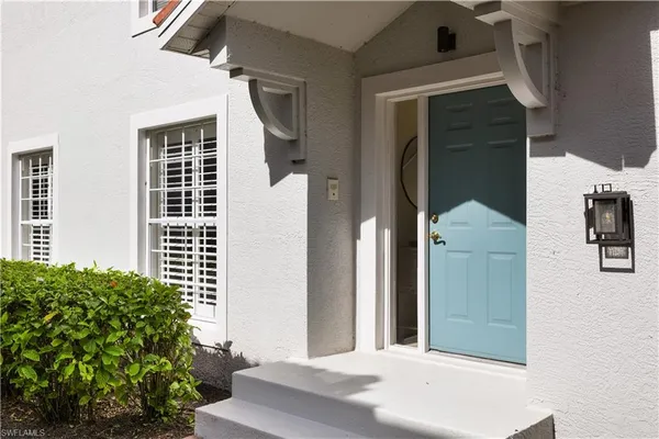a view of a house with a door and balcony