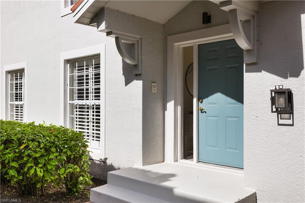 2180 Arielle Drive, Unit 810 Naples, FL 34109 - Photo 2 of 25 a view of a house with a door and balcony