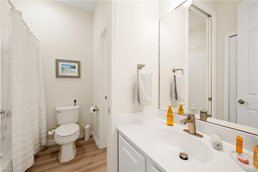 2180 Arielle Drive, Unit 810 Naples, FL 34109 - Photo 22 of 25 a bathroom with a toilet sink and a mirror
