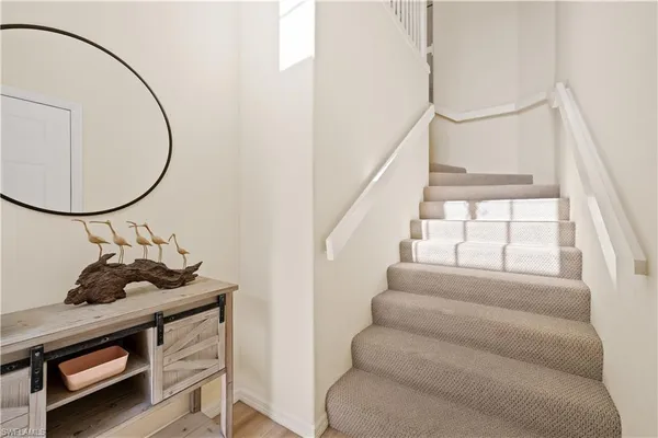a room with stairs and a mirror