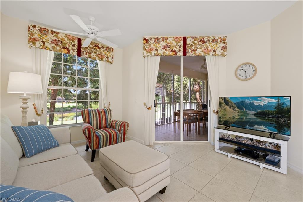 2180 Arielle Drive, Unit 810 Naples, FL 34109 - Photo 6 of 25 a living room with furniture and a flat screen tv