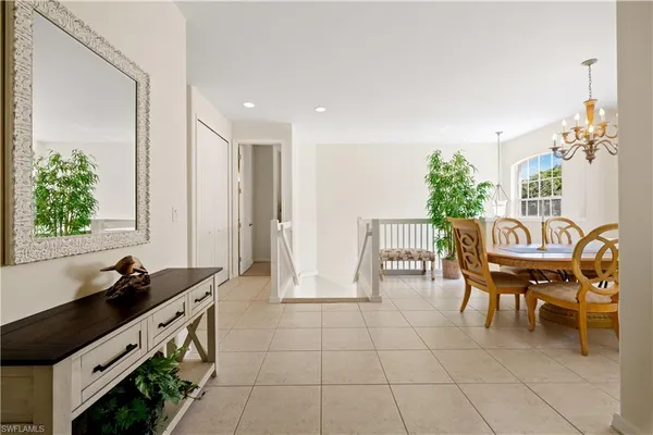 a dining room with furniture and a floor to ceiling window