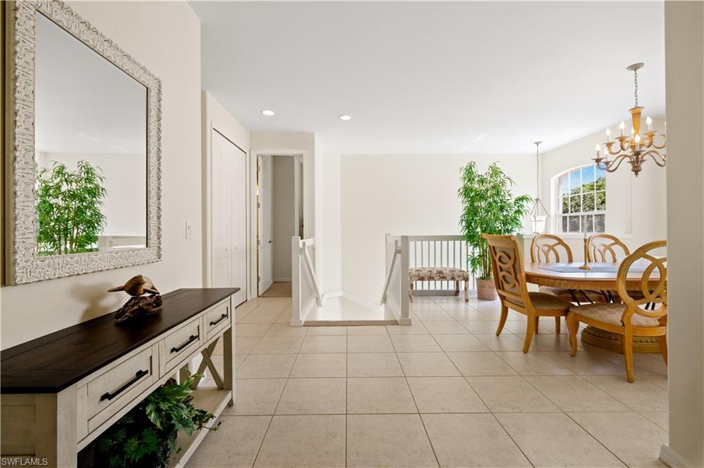 2180 Arielle Drive, Unit 810 Naples, FL 34109 - Photo 8 of 25 a dining room with furniture and a floor to ceiling window