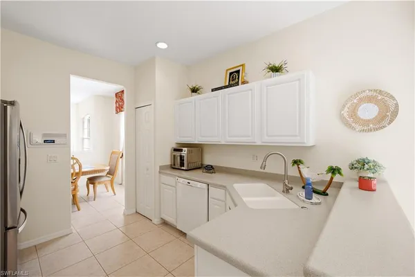 a kitchen with a sink cabinets and appliances