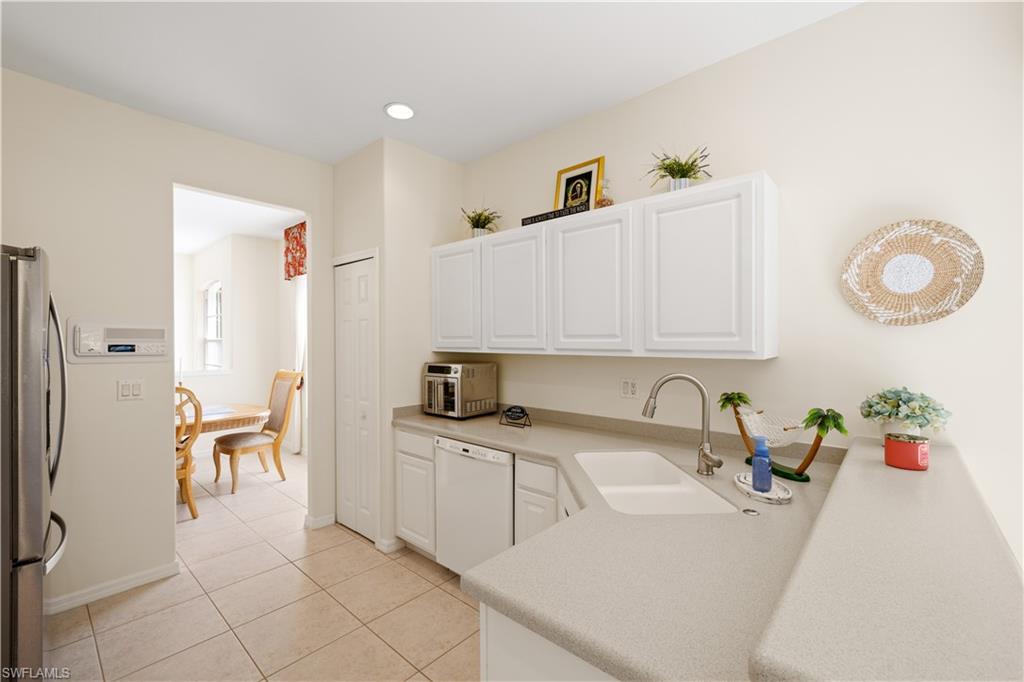 2180 Arielle Drive, Unit 810 Naples, FL 34109 - Photo 10 of 25 a kitchen with a sink cabinets and appliances