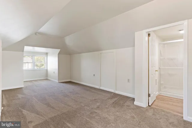 a view of a room with wooden floor and windows