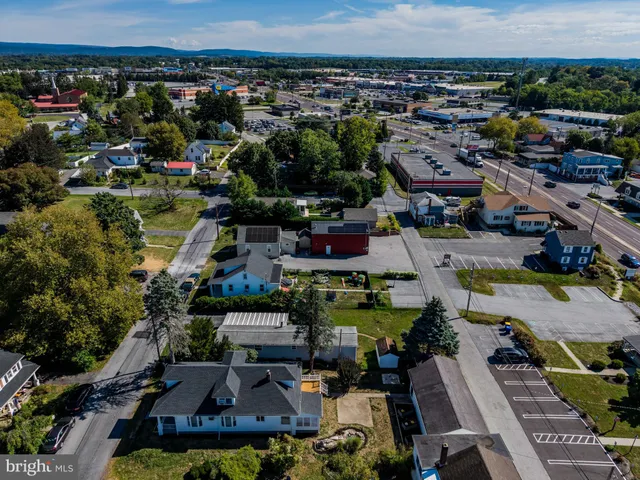 a aerial view of a house with a garden and patio