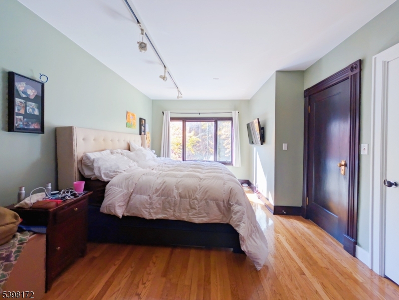 296 Glen Avenue Short Hills, NJ 07078 - Photo 11 of 25 a bedroom with a bed and wooden floor