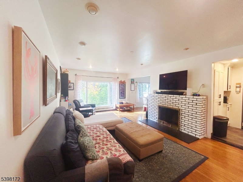 296 Glen Avenue Short Hills, NJ 07078 - Photo 4 of 25 a living room with furniture or fireplace and a flat screen tv
