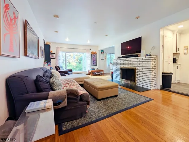a living room with furniture flat screen tv and a fireplace