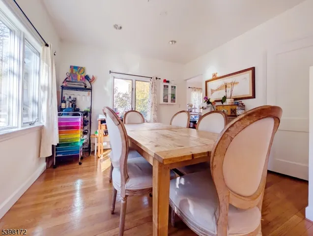 a view of a dining room with furniture wooden floor and a window