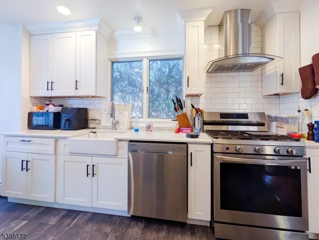 a kitchen with cabinets a sink and appliances
