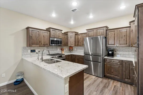 a kitchen with kitchen island a sink appliances and cabinets