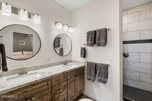 a bathroom with a double vanity sink and a mirror