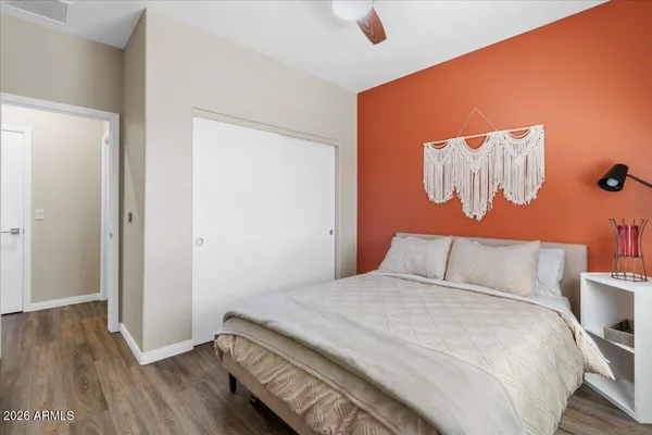a bedroom with a bed and wooden floor