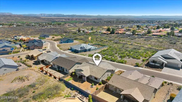 an aerial view of a house with a mountain