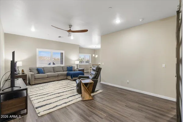 a living room with furniture and a wooden floor