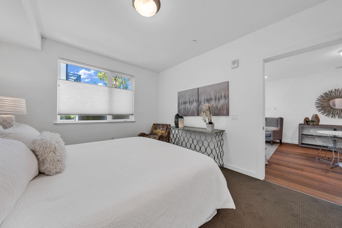 400 El Camino Real, Unit 117 Belmont, CA 94002 - Photo 11 of 54 a bedroom with a large bed and a table