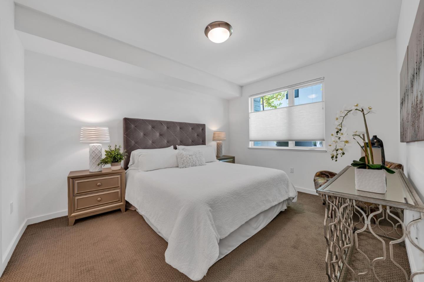 400 El Camino Real, Unit 117 Belmont, CA 94002 - Photo 14 of 54 a bedroom with a bed and window