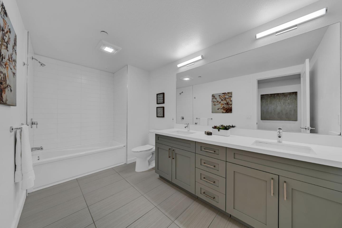 400 El Camino Real, Unit 117 Belmont, CA 94002 - Photo 22 of 54 a bathroom with a double vanity sink a large mirror and a bathtub