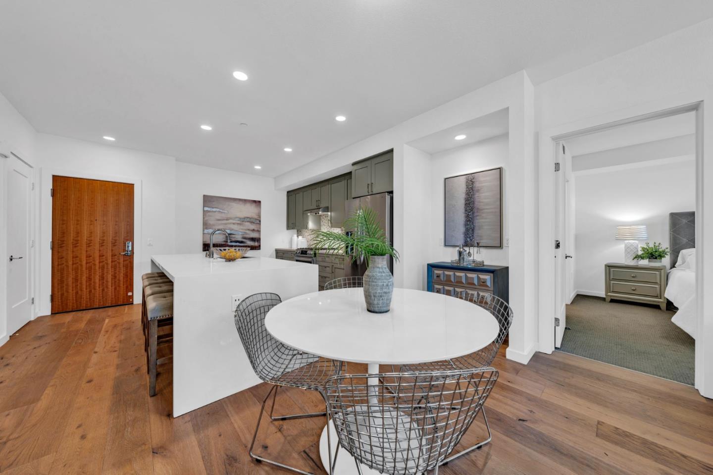 400 El Camino Real, Unit 117 Belmont, CA 94002 - Photo 3 of 54 a living room with furniture a table and kitchen view