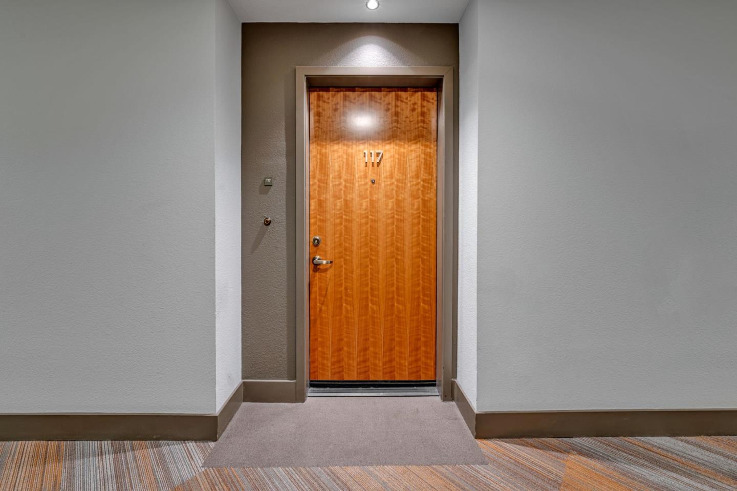 400 El Camino Real, Unit 117 Belmont, CA 94002 - Photo 34 of 54 a view of a hallway with wooden floor and a bathroom