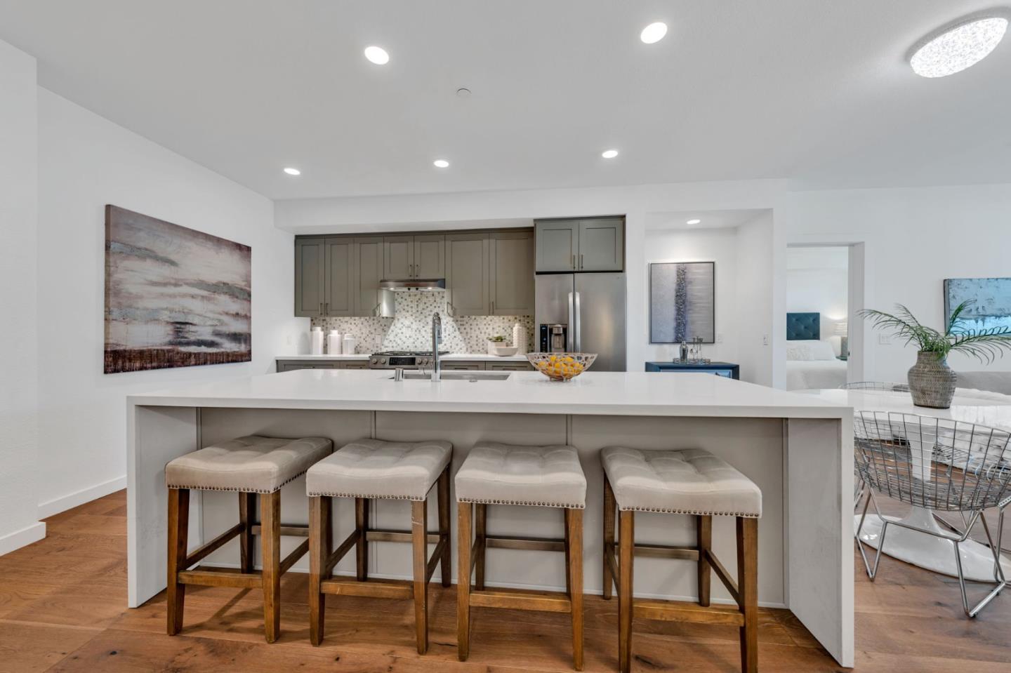 400 El Camino Real, Unit 117 Belmont, CA 94002 - Photo 5 of 54 a kitchen with kitchen island cabinets and chairs in it