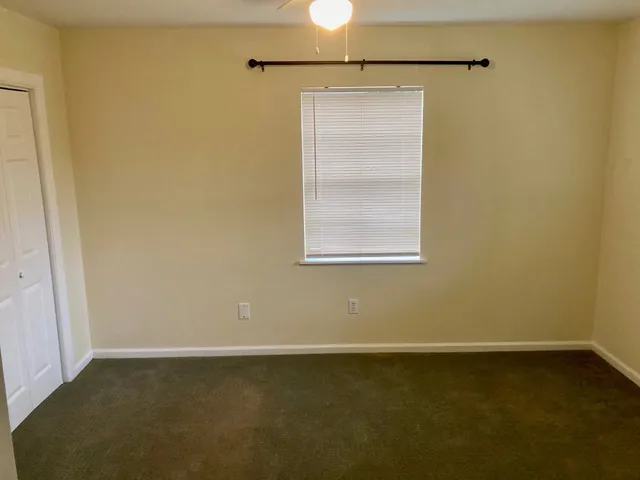 a view of a small space with wooden floor and a window