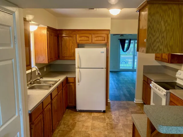 a kitchen with a refrigerator sink and stove