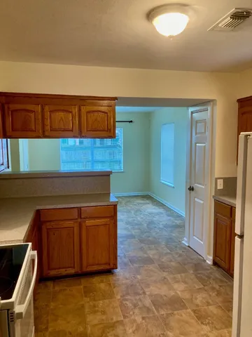 a kitchen with stainless steel appliances a refrigerator and a stove