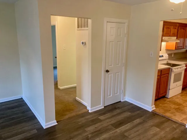 a view of a hallway with wooden floor